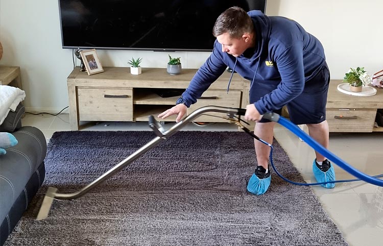 Trent Rowland from Happy Floors Gold Coast. Action pic of Trent Steam Cleaning Carpets
